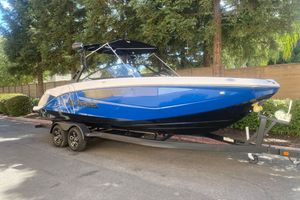 Scarab 255 ID 2025 Scarab 255 ID boat in blue on a trailer, parked outdoors.