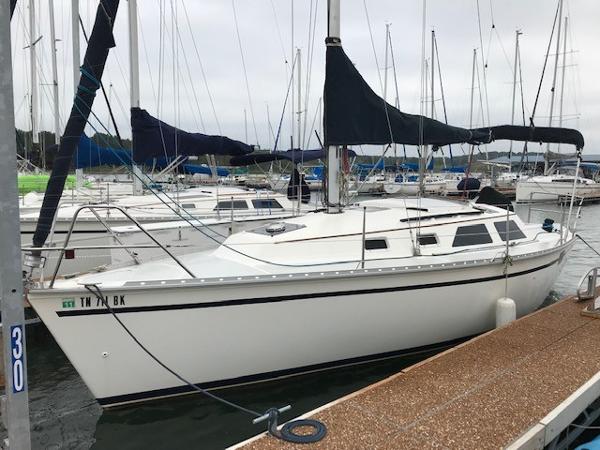 Hunter 28 Hunter 28 sailboat from 1990 docked at a marina, surrounded by other boats.