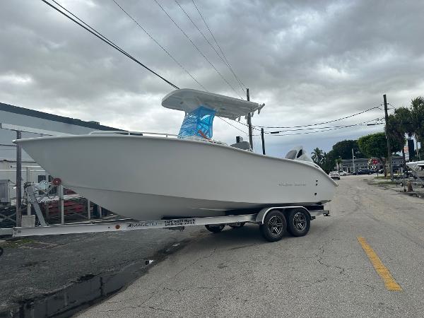Cape Horn 22OS 2024 Cape Horn 22OS boat on trailer, parked on a street under cloudy skies.
