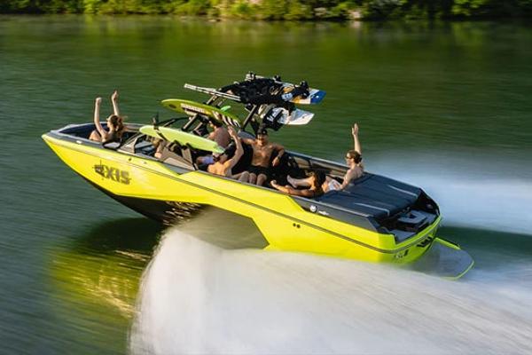 Axis A245 Manufacturer Provided Image: 2026 Axis A245 boat speeding on water with passengers enjoying the ride.