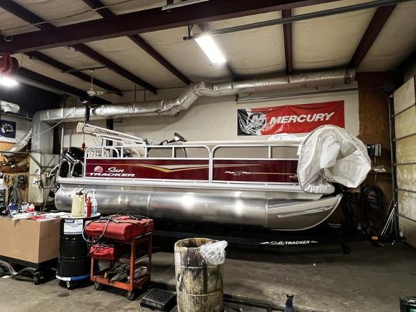 Sun Tracker Bass Buggy® 16 XL Select 2023 Sun Tracker Bass Buggy® 16 XL Select pontoon boat in a workshop.
