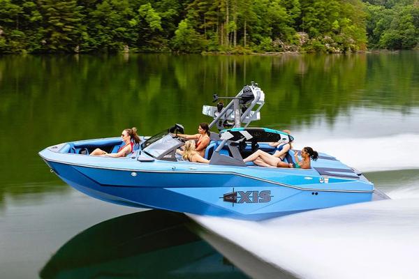 Axis T220 Manufacturer Provided Image: 2026 Axis T220 boat cruising on a serene lake with passengers enjoying the ride.