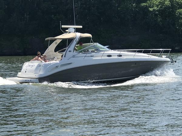 Sea Ray 360 Sundancer 2005 Sea Ray 360 Sundancer cruising on a sunny day, surrounded by lush greenery.