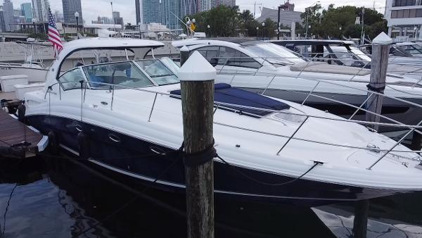 Sea Ray 420 Sundancer 2005 Sea Ray 420 Sundancer yacht docked at marina with city skyline in background.