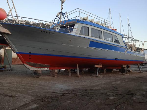 Commercial Passengers Motor Boat 1976 commercial passenger motor boat on dry dock, featuring blue and red accents.