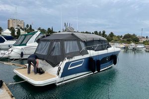 Prestige 420S 2022 Jeanneau Prestige 420S yacht docked in marina, covered with protective canopy.