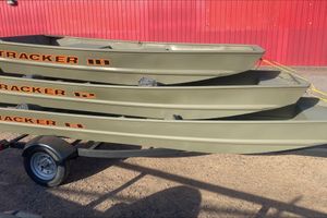 Tracker Grizzly 10 Jon Stacked 2026 Tracker Grizzly 10 Jon boats on trailer, against red wall.