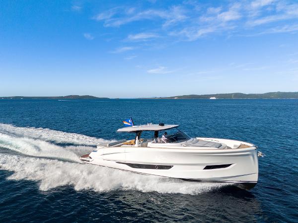 Solaris Power 60 Open 2025 Solaris Power 60 Open yacht cruising on open sea under clear blue sky.