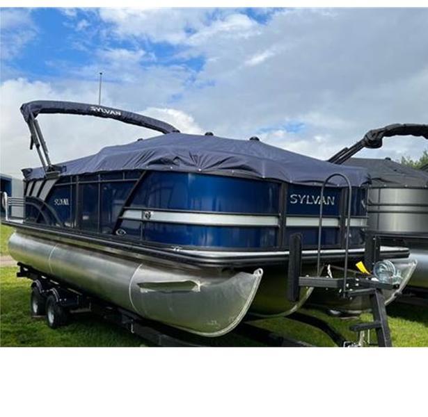 Sylvan Mirage X X3 2025 Sylvan Mirage X X3 pontoon boat with cover on trailer, under a partly cloudy sky.