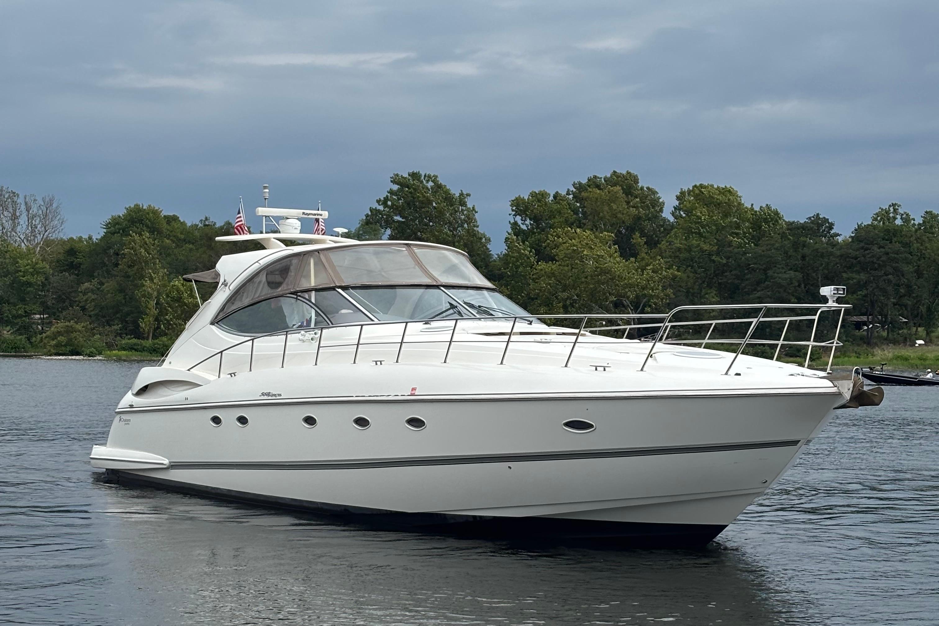 Cruisers Yachts 560 Express 2006 Cruisers Yachts 560 Express on calm water with lush green background.