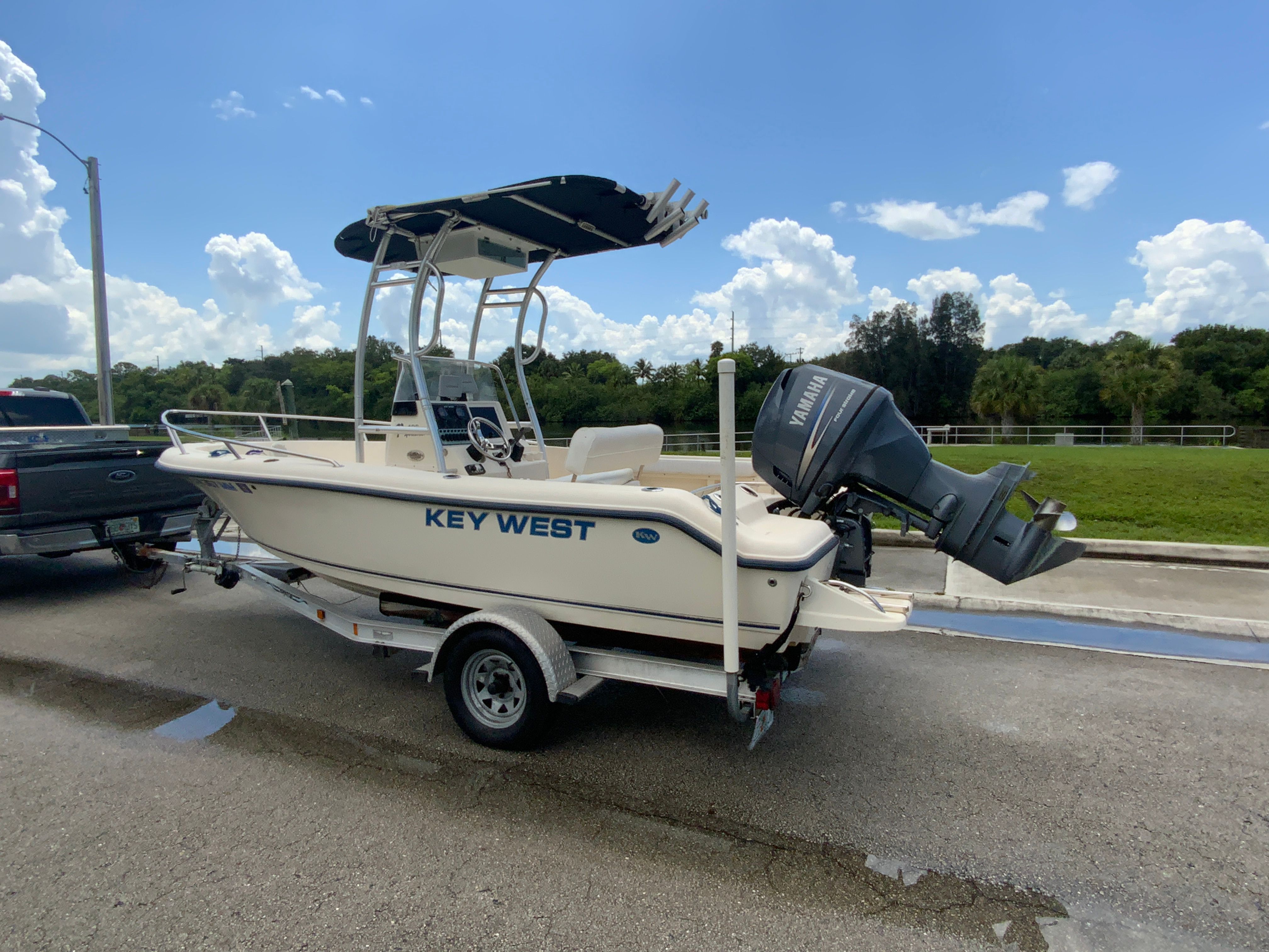 Key West 186 2014 Key West 186 boat on trailer with Yamaha outboard motor, parked roadside.