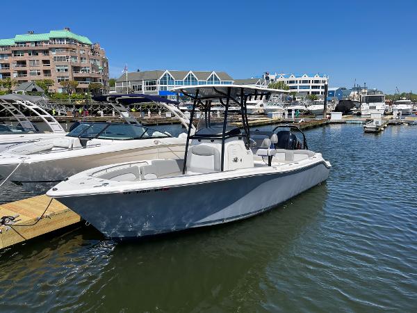 NauticStar 2302 Legacy 2021 NauticStar 2302 Legacy boat docked in a marina under clear blue skies.