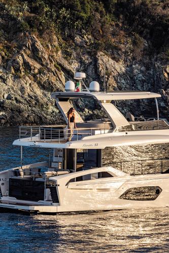 Absolute 53 Navetta Luxury Absolute 53 Navetta yacht cruising near rocky coastline, 2025 model.