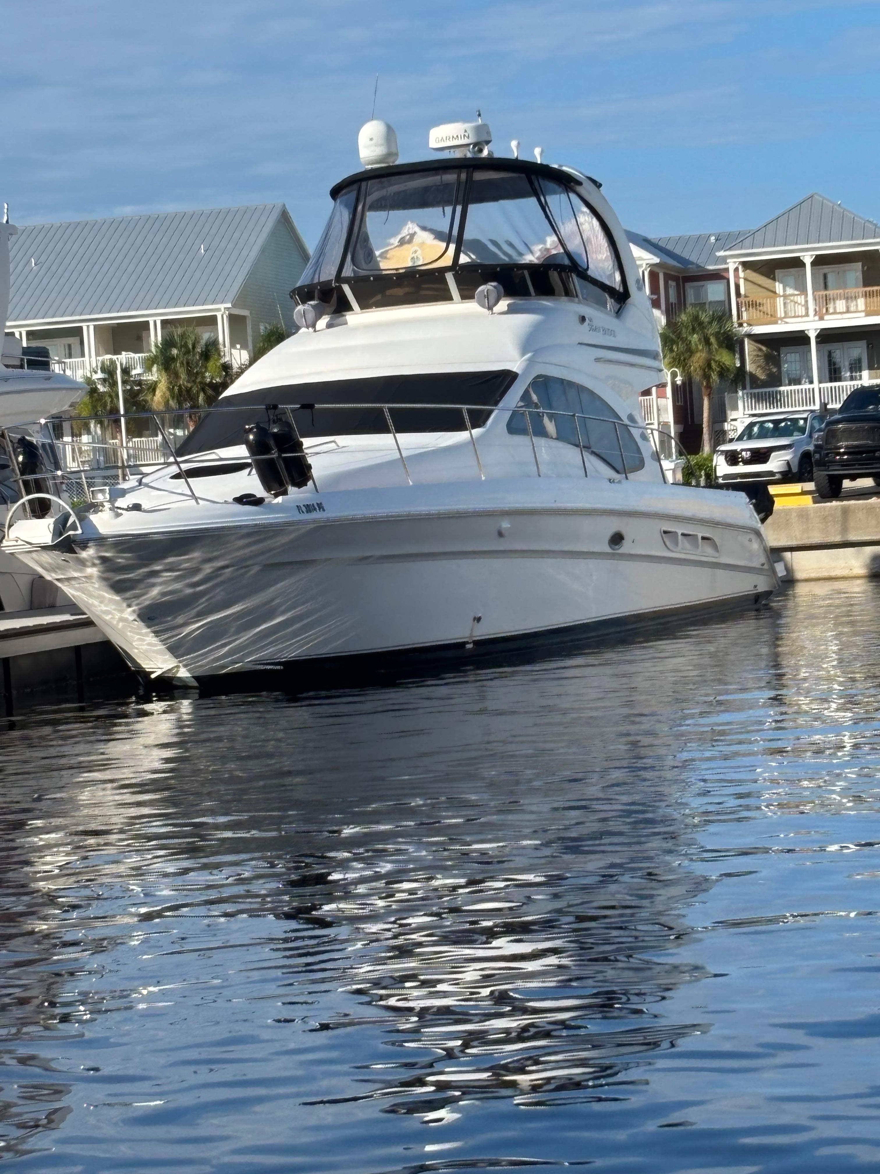 Sea Ray 44 Sedan Bridge 2008 Sea Ray 44 Sedan Bridge yacht docked in marina, reflecting on water.