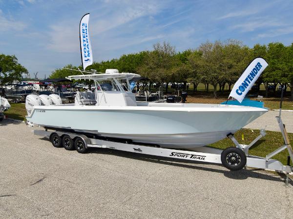 Contender 39 ST 2024 Contender 39 ST boat on a Sport Trail trailer at a dealership.