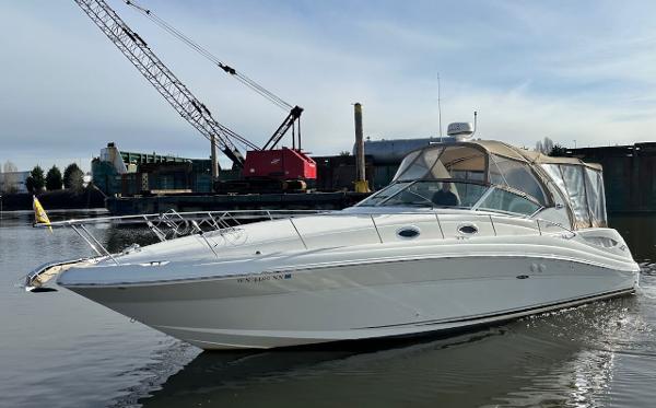 Sea Ray 340 Sundancer 2004 Sea Ray 340 Sundancer boat docked in a marina with industrial background.