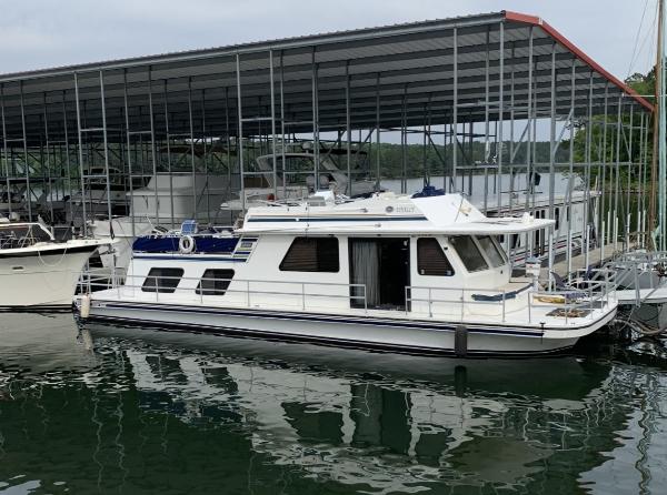 Gibson 50 Cabin Yacht 1994 Gibson 50 Cabin Yacht docked at marina under covered shelter.
