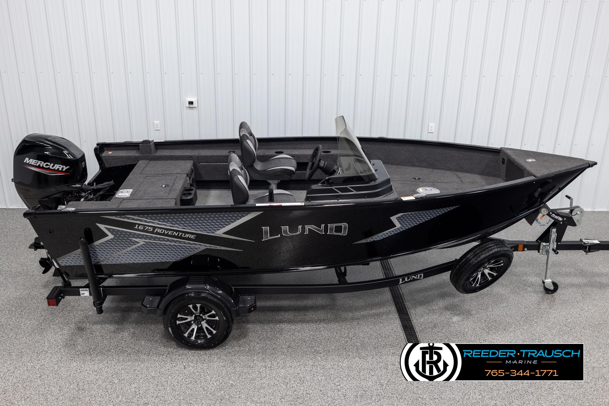 Lund Adventure SS 2025 Lund Adventure SS boat with Mercury engine on trailer in showroom.