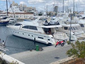 Falcon 86 Luxury Falcon 86 yacht docked at marina, featuring jet skis and a motorcycle, 2008 model.