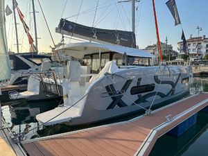 Excess 11 2024 Excess 11 catamaran docked at marina, showcasing sleek design and modern features.