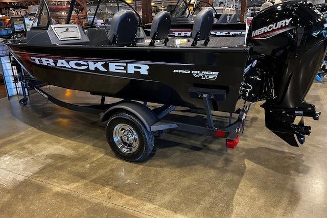 Tracker Pro Guide V-16 WT 2026 Tracker Pro Guide V-16 WT boat with Mercury engine on display indoors.