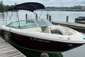 Sea Ray 220 Select 2006 Sea Ray 220 Select boat docked by a serene lake with a bridge view.
