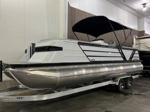 Veranda VX 25 DCRC 2025 Veranda VX 25 DCRC pontoon boat with black canopy on trailer in indoor storage.
