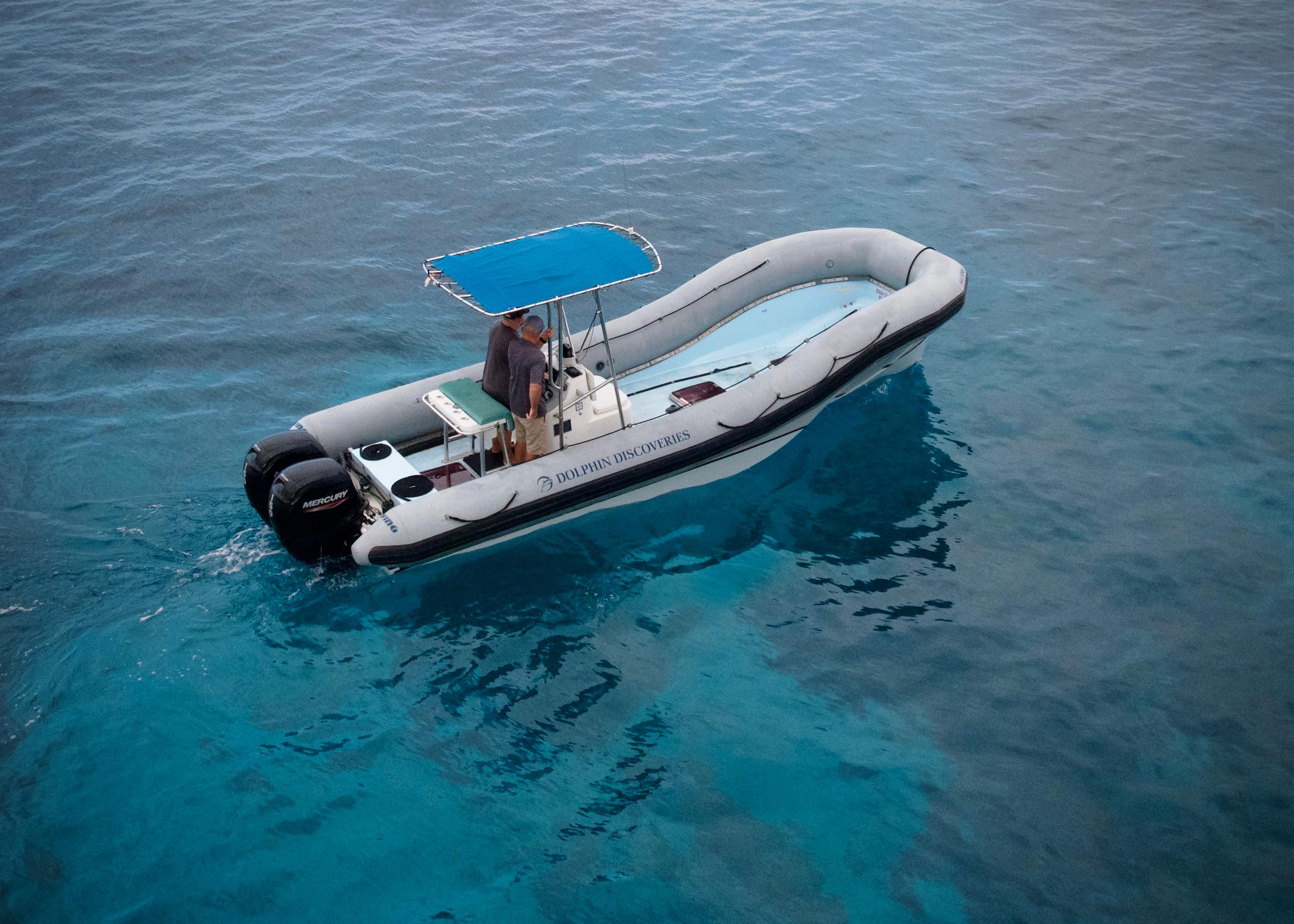 Sea Blade Navatek Sled (RIB) 2007 Sea Blade Navatek Sled RIB with blue canopy on clear ocean water.
