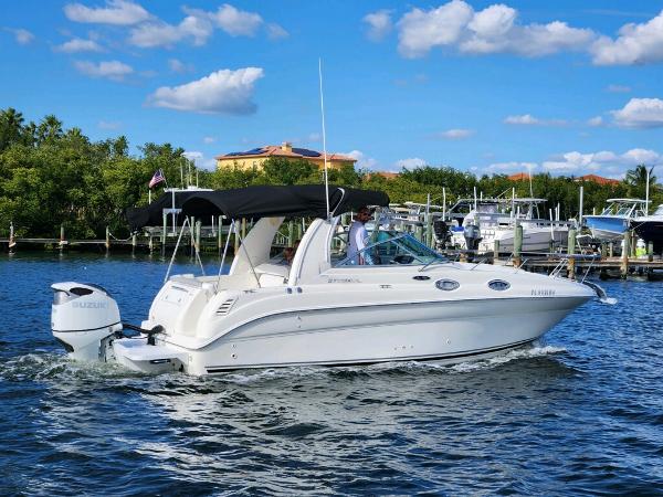 Sea Ray 260 Sundancer 2003 Sea Ray 260 Sundancer cruising on a sunny day, with a black canopy.
