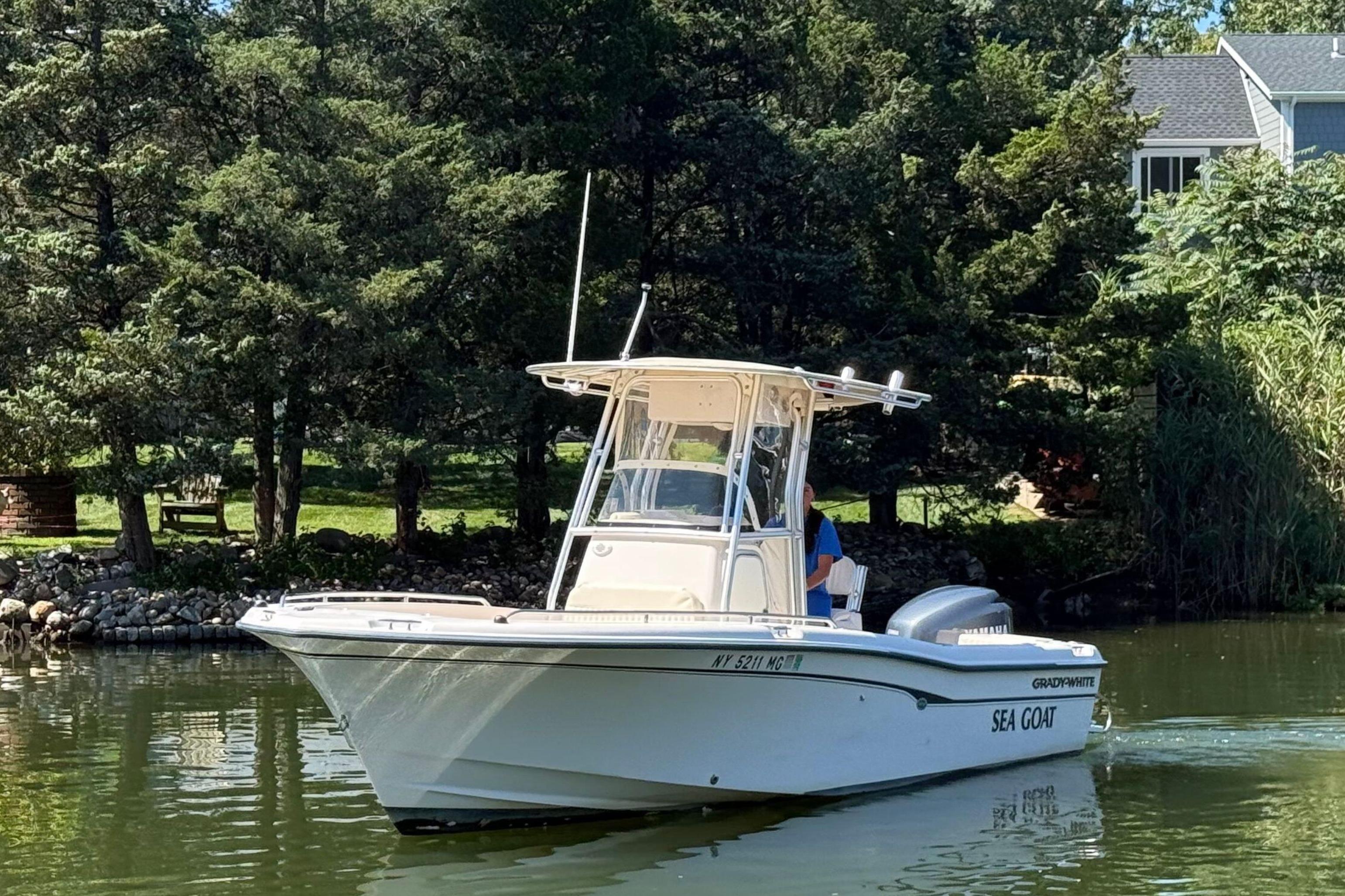 Grady-White Fisherman 222 2008 Grady-White Fisherman 222 boat on a serene lake, surrounded by lush greenery.