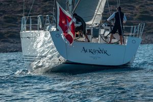 X-Yachts X-65 Sailing yacht X-Yachts X-65 from 2009 on open water, rear view with flag.