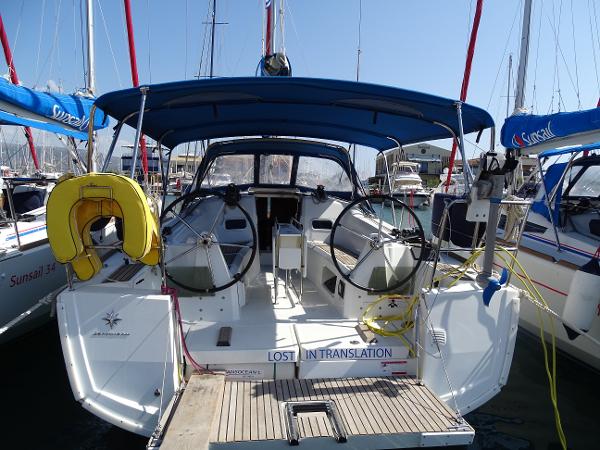 Jeanneau Sun Odyssey 349 2017 Jeanneau Sun Odyssey 349 sailboat docked with blue canopy and dual steering wheels.