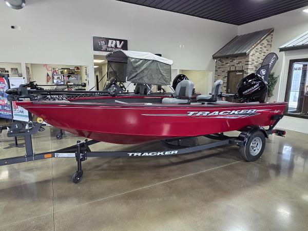 Tracker Super Guide V 16 T 2025 Tracker Super Guide V 16 T boat in showroom, red exterior, on trailer.