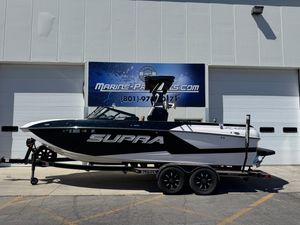 Supra SL 550 2021 Supra SL 550 boat on trailer outside Marine Products store.