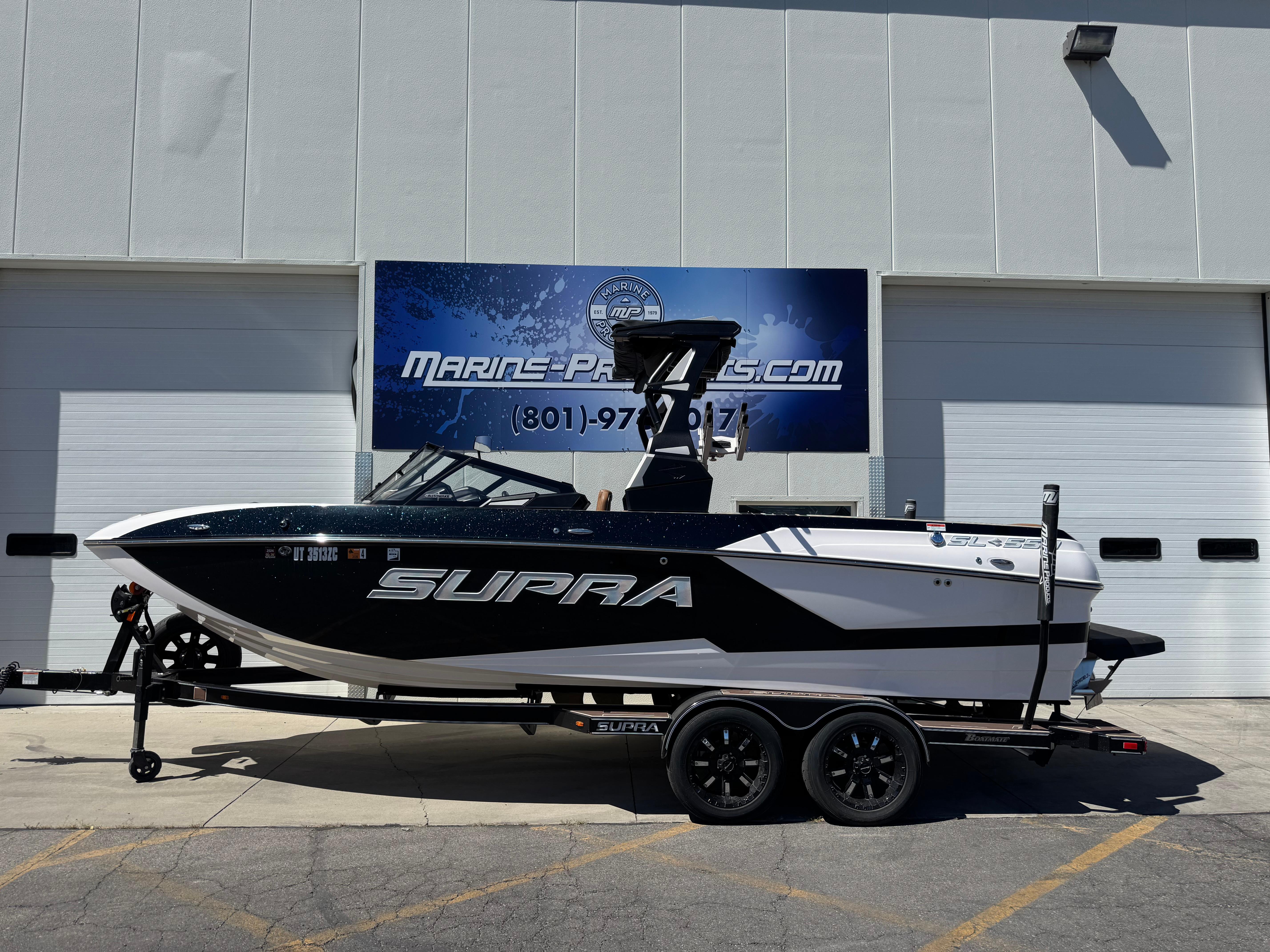 Supra SL 550 2021 Supra SL 550 boat on trailer outside Marine Products store.
