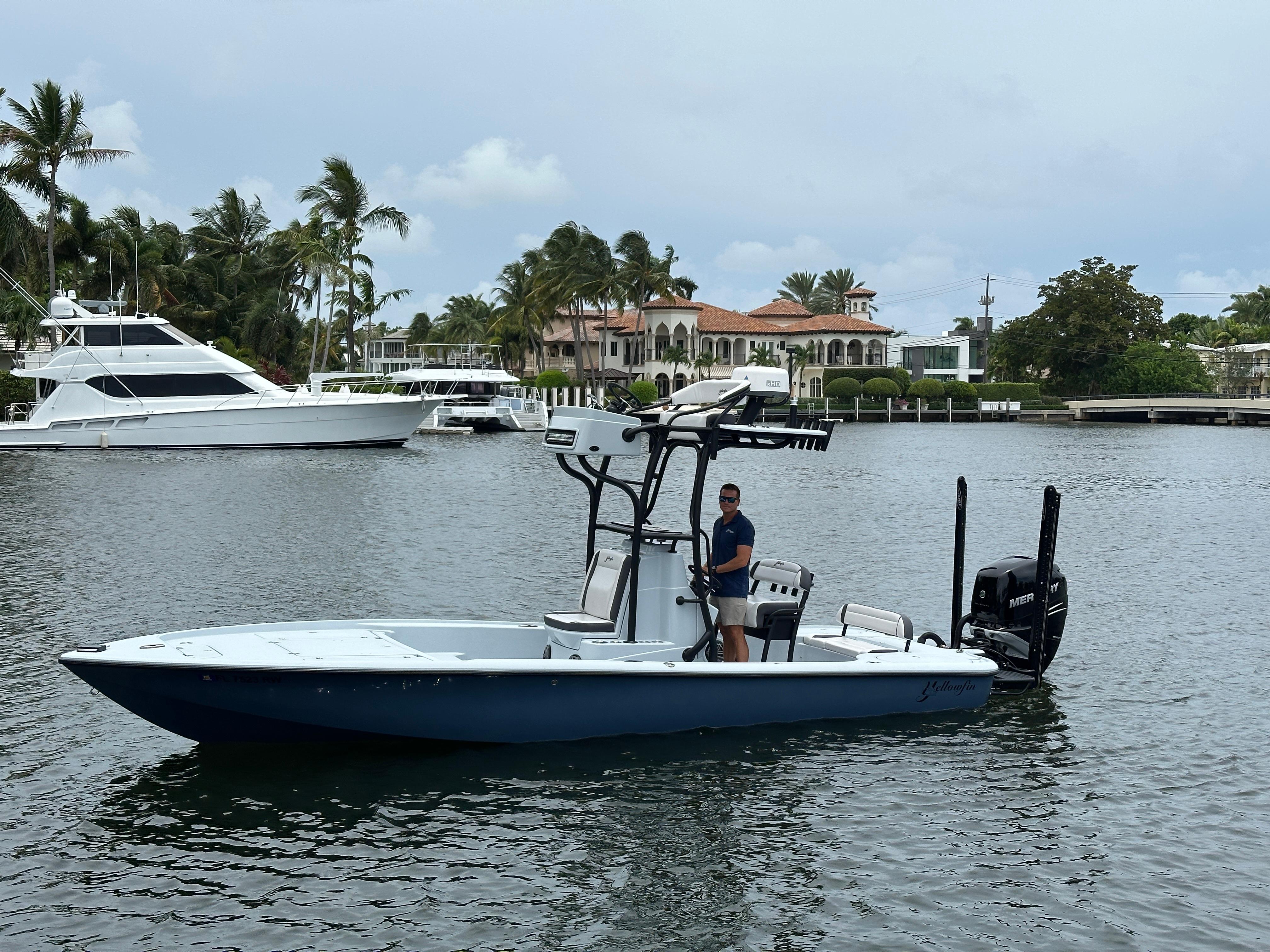 Yellowfin 24 Bay CE 2019 Yellowfin 24 Bay CE boat on water, with palm trees and luxury homes in background.