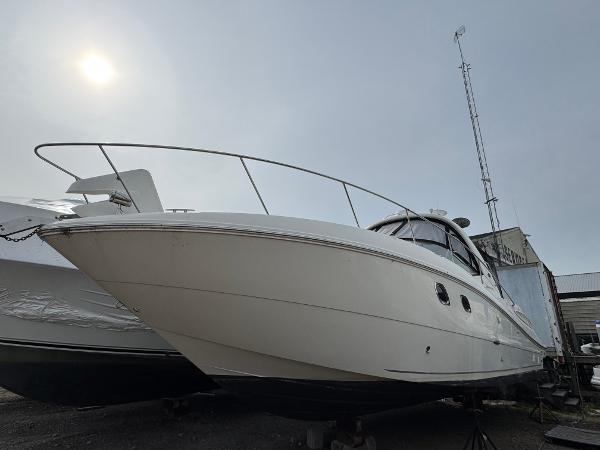 Sea Ray 330 Sundancer 2008 Sea Ray 330 Sundancer boat on dry dock under a cloudy sky.