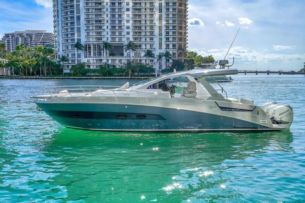 Azimut Verve 40 2020 Azimut Verve 40 yacht on turquoise water with cityscape background.