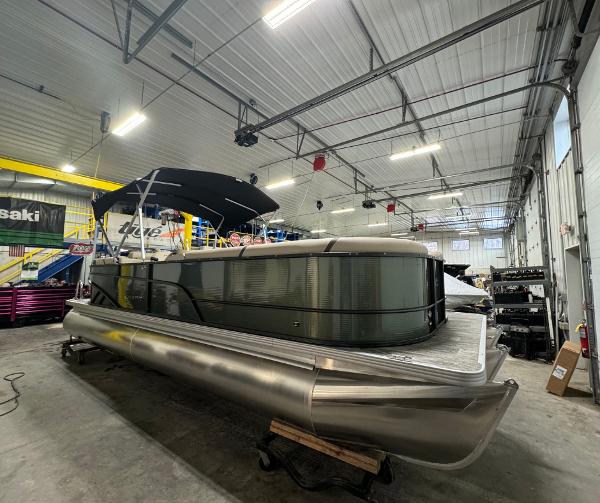 Crest Classic LX 240 2024 Crest Classic LX 240 pontoon boat in a warehouse.