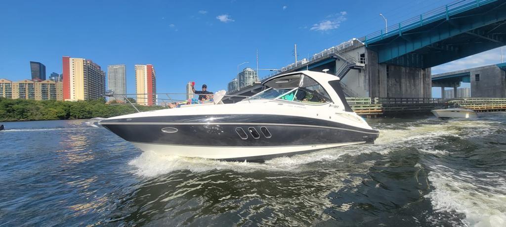 Cruisers Yachts 350 Express 2012 Cruisers Yachts 350 Express navigating under a bridge in an urban waterway.