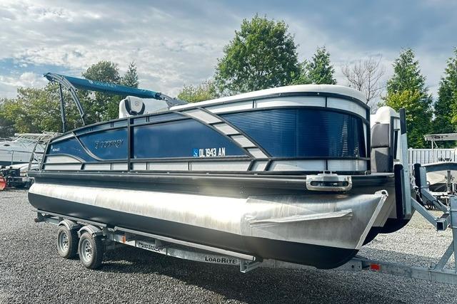 Godfrey Monaco 235RL Tri Toon 2021 Godfrey Monaco 235RL Tri Toon boat on trailer, parked outdoors.