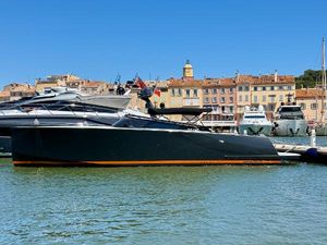 VanDutch 40 2024 VanDutch 40 yacht docked in a picturesque harbor with historic buildings.