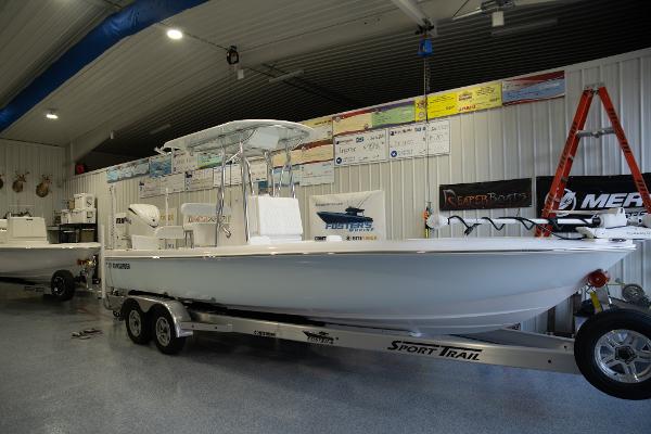 Contender 26 Bay 2025 Contender 26 Bay boat on trailer in showroom.