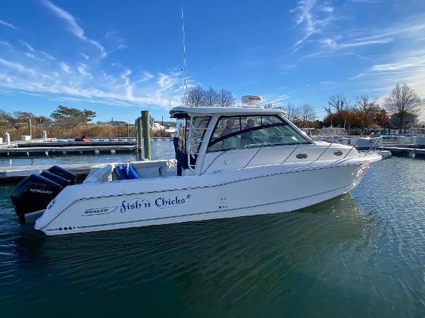 Boston Whaler 345 Conquest 2020 Boston Whaler 345 Conquest boat docked in marina under clear blue sky.