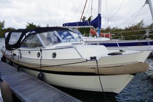 Intercruiser 27 Cabin 2012 Intercruiser 27 Cabin boat docked, featuring sleek design and protective canopy.