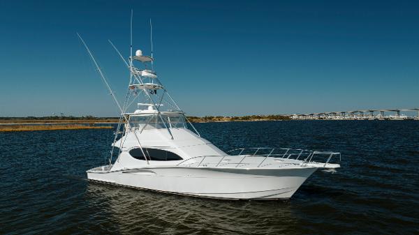 Hatteras 54 Convertible 2005 Hatteras 54 Convertible yacht on calm water under clear blue sky.