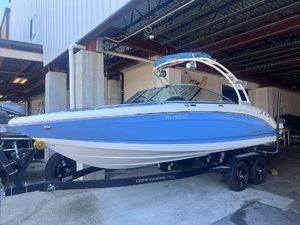 Chaparral 23 Surf 2022 Chaparral 23 Surf boat in blue and white on a trailer.