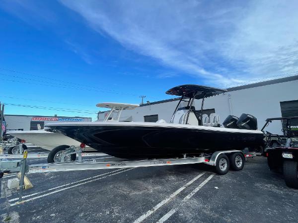 ShearWater 270 SS CAROLINA 2024 ShearWater 270 SS Carolina boat on trailer, parked outdoors under blue sky.