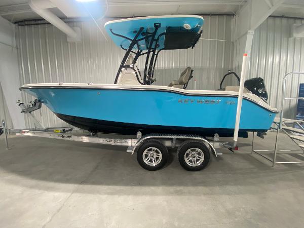 Key West 219 FS 2024 Key West 219 FS boat on a trailer in a showroom.