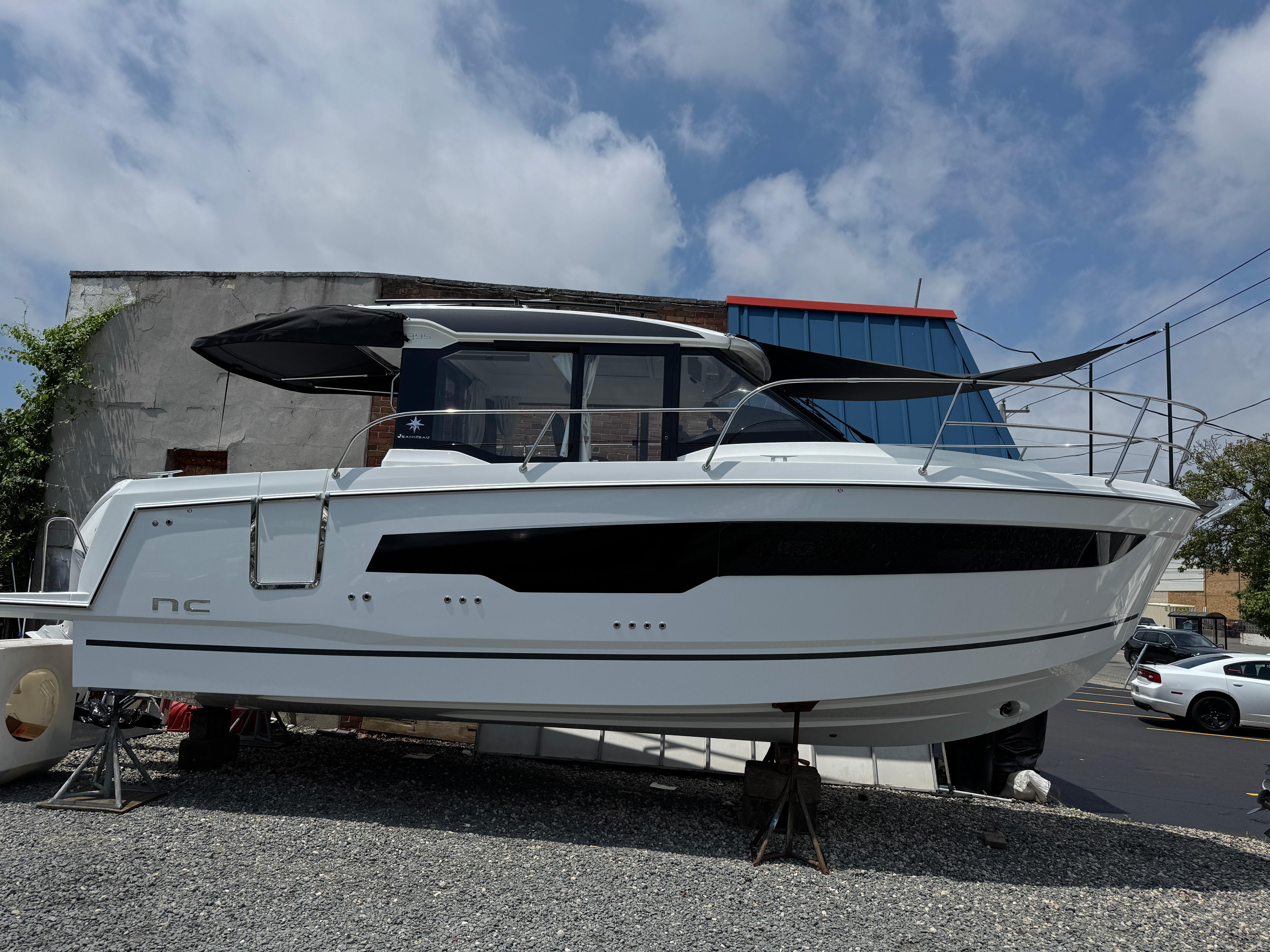 Jeanneau NC 895 Series 2 2025 Jeanneau NC 895 Series 2 boat displayed outdoors on gravel.